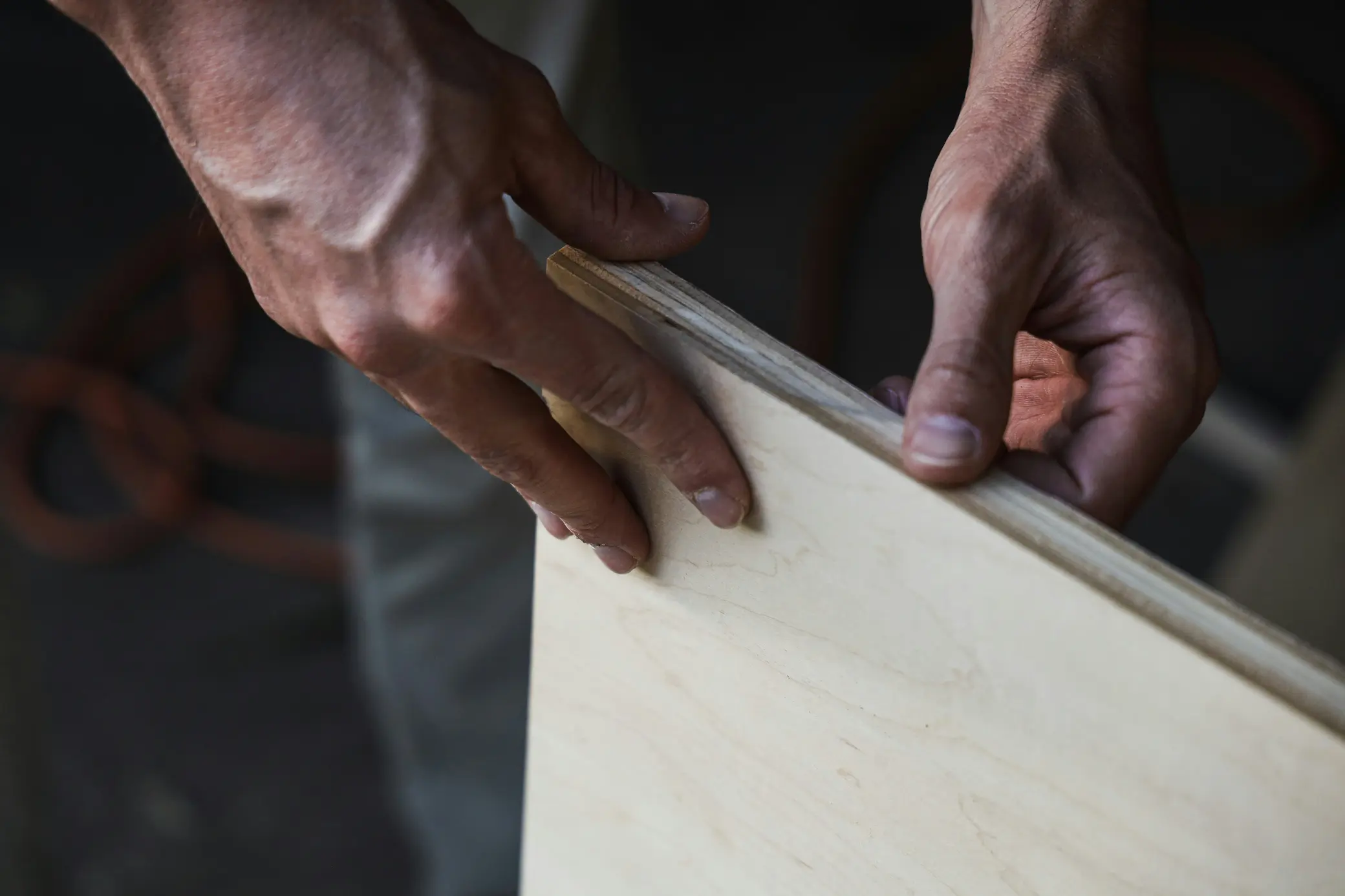 Carpenter working with plywood in a workshop